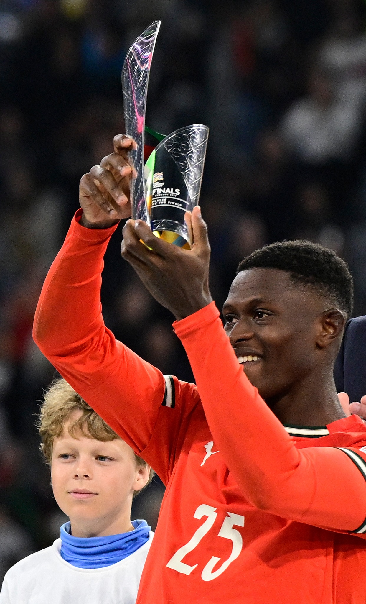 Portugal's defender #25 Nuno Mendes receives the best player award after the UEFA Nations League final football match between Portugal and Spain in Munich, southern Germany on June 8, 2025. (Photo by John MACDOUGALL / AFP) (Photo by JOHN MACDOUGALL/AFP via Getty Images)