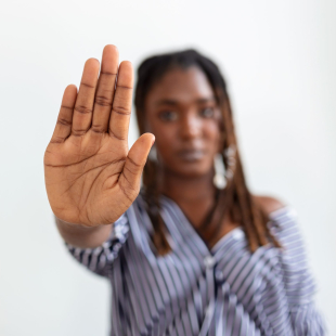woman raised her hand for dissuade, campaign stop violence against women. African American woman raised her hand for dissuade with copy space