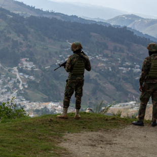 PORT-AU-PRINCE, HAITI - FEBRUARY 03: Soldiers position themselves during an anti-gang operation in the Kenscoff district of Port-au-Prince, Haiti, Monday, Feb. 3, 2025. Armed gangs have once again attacked the commune of Kenscoff, east of Port-au-Prince, more precisely at Godt in the Bzlot area, despite the presence of law enforcement forces. From Monday 27 January to 3 February 2025, more than a hundred displaced persons took refuge in the courtyard of the Kenscoff town hall, located in the centre of the town, where commercial and school activities remain paralysed. These displaced people are receiving assistance from the Civil Protection and the World Food Programme (WFP). The population is still in shock after the attack in Kenscoff on Monday 27 January 2025. Guerinault Louis / Anadolu (Photo by Guerinault Louis / ANADOLU / Anadolu via AFP)